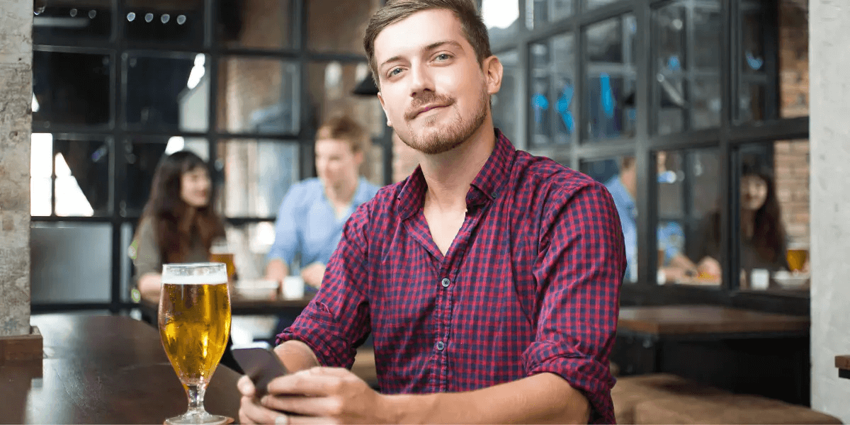 Content man drinking beer by himself