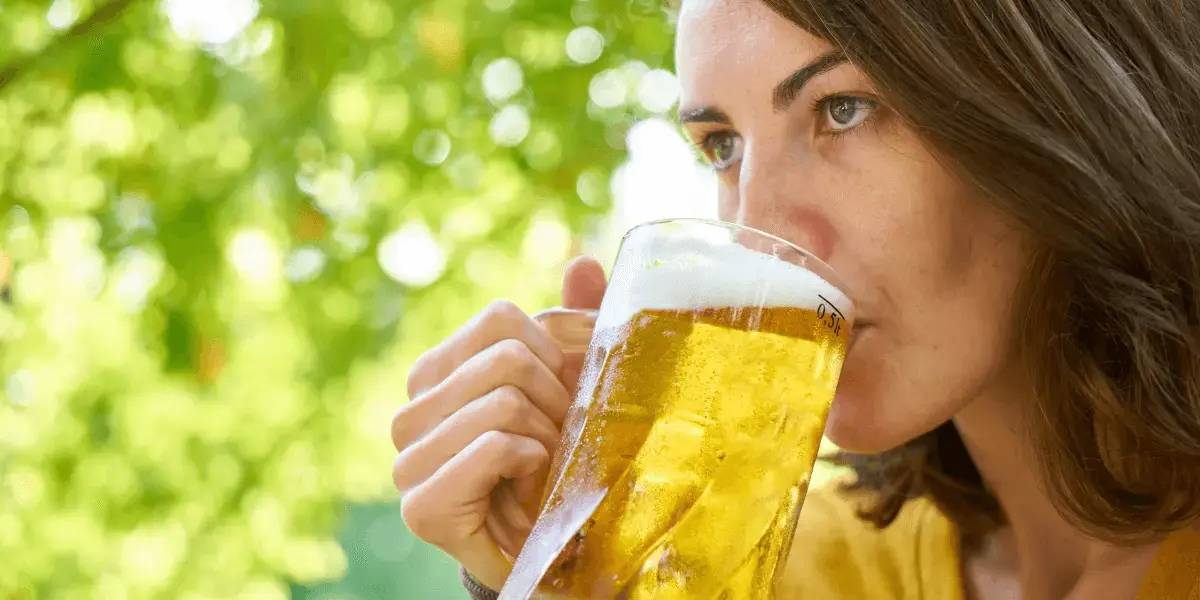 Woman drinking a beer outdoors