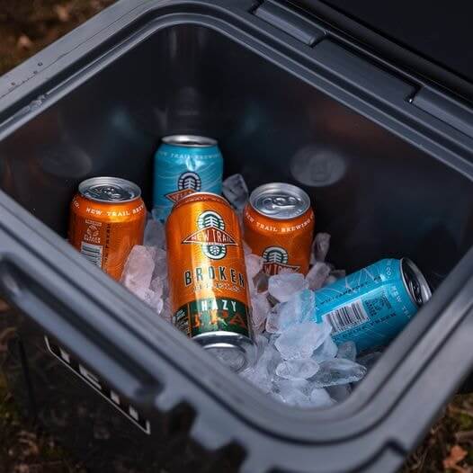 New Trail Brewing Co canned beers in a cooler