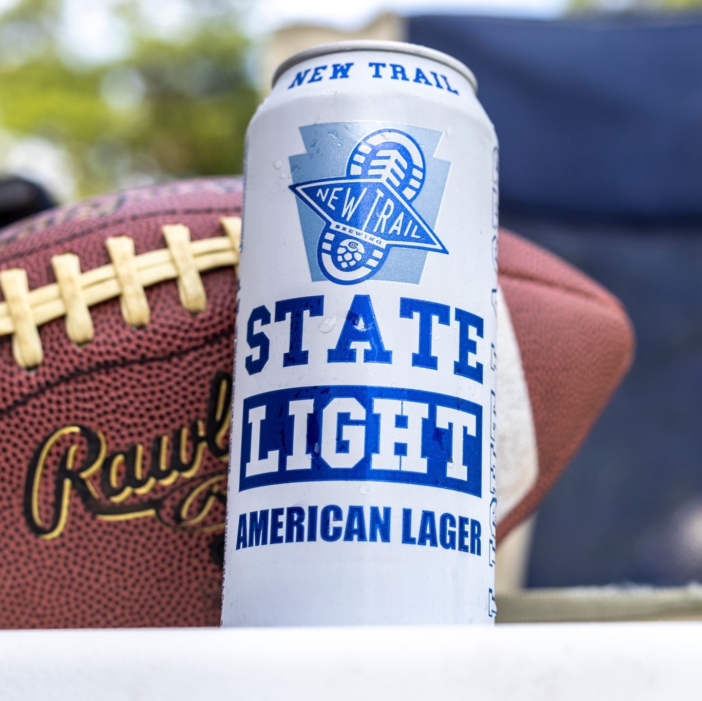 State Light canned beer next to a football