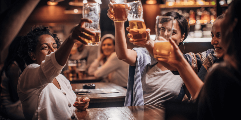 Friends Toasting and Drinking Beer in Glasses