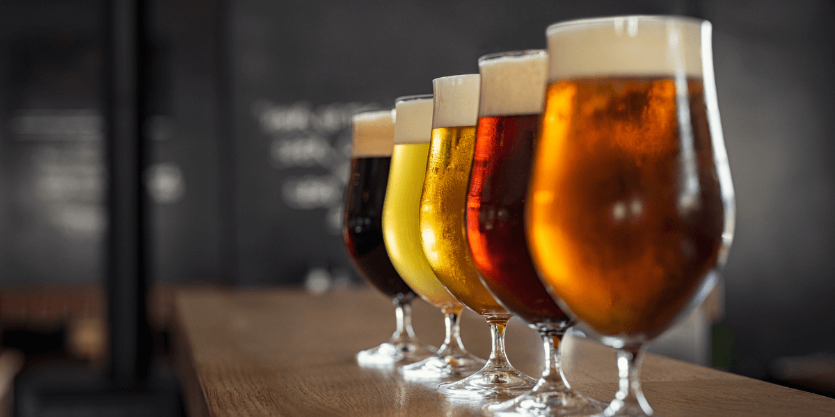 different kinds of craft beer on a wooden bar