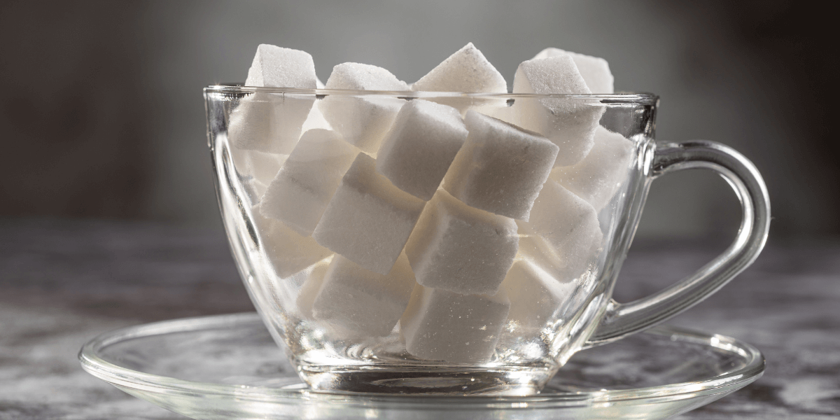 white sugar cubes in transparent mug