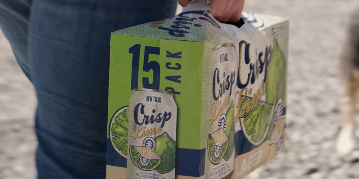 man carrying a 15-pack New Trail Crisp Lime Lager